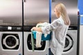 rear view on woman came to put clothes to wash Royalty Free Stock Photo