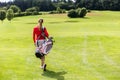 Rear view of woman carrying golf bag Royalty Free Stock Photo