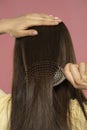 Rear view of a woman enjoying brushing healthy hair Royalty Free Stock Photo