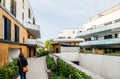 Rear view of woman entering the territory of modern condominium building Royalty Free Stock Photo