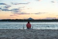 Rear View of Woman Fishing on the Beach at Sunset Time in Noosa, Australia.Lifestyle Concept Royalty Free Stock Photo