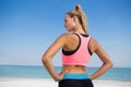 Rear view of woman with hand on hip at beach Royalty Free Stock Photo