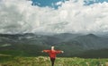 Rear view woman hiker standing on top of mountain with open arms. Feeling freedom and harmony. Royalty Free Stock Photo