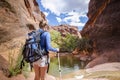 Rear view of a Woman hiking to a waterfall in a red rock canyon Royalty Free Stock Photo