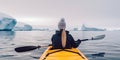 Rear view of woman kayaking at Antarctica