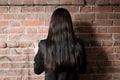 Rear view of a woman with long brown hair against Royalty Free Stock Photo