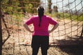 Rear view of woman looking at net during obstacle course Royalty Free Stock Photo