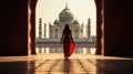 Rear view of woman looking at Taj Mahal, The magnificent Taj Mahal in India shows its full splendor at a glorious sunrise