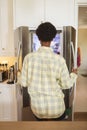 Rear view of woman opening the fridge Royalty Free Stock Photo