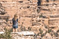 Rear View Of Woman Photographing Rocky Mountain With Smartphone