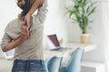 Rear view of woman praciticing gomukhasana or cow face yoga pose at home office. Back of woman doing stretching exercise with her Royalty Free Stock Photo