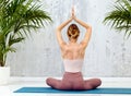 Rear view of a woman practicing the Sukhasana yoga pose Royalty Free Stock Photo