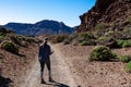 Rear view of woman on scenic hiking trail through a canyon near Montana Majua in volcano Mount Teide National Park, Tenerife Royalty Free Stock Photo