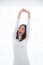 Rear view of woman stretching in bed after wake up in morning. Royalty Free Stock Photo