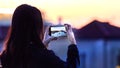 Rear view of a woman taking photos with her mobile of the Grand Canal in Venice, Italy