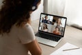 Rear view of woman talk on video call with girlfriends Royalty Free Stock Photo