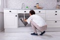 Woman Trying To Stop Water Leakage From Sink Pipe Royalty Free Stock Photo