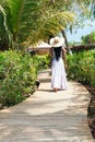 Rear view of a woman walking on an ecological trail