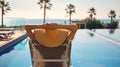 Rear view woman wear hat lying on deckchair on poolside Royalty Free Stock Photo