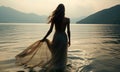 Rear view woman wearing long flowing beautiful dress in water, Moody melancholic