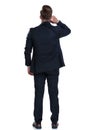 Rear view of a wondering businessman scratching his neck Royalty Free Stock Photo