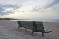 Rear view of an wooden bench on a deserted sandy beach