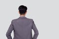 Rear view of young asian businessman in suit hand in pocket with confident isolated on white background. Royalty Free Stock Photo