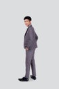 Rear view of young asian businessman in suit hand in pocket with confident isolated on white background. Royalty Free Stock Photo