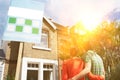 Rear view of young couple looking at new home with for sale sign Royalty Free Stock Photo