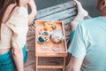 Rear view of young couple on picnic near river or lake, woman and man drinking wine outdoors Royalty Free Stock Photo