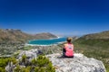 Rear view of young female hiker woman looking at Hout Bay near Cape Town Royalty Free Stock Photo