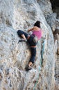 Rear view of young female rock climber on cliff Royalty Free Stock Photo