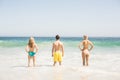 Rear view of young friends standing on the beach Royalty Free Stock Photo