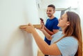 Man using a drill to install bookshelf on the wall Royalty Free Stock Photo