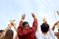 rear view on young happy people having party outdoors, raising hand up celebrating Royalty Free Stock Photo