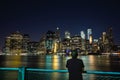 A Young Man watching the View of Manhattan Skyline from Brooklyn at Night - New York City, USA Royalty Free Stock Photo