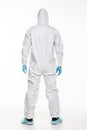 Rear view of Young man in chemical protective suit making stop gesture on white background. Virus research Royalty Free Stock Photo