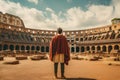 Rear view of young man in costume looking at Colosseum in Rome, Italy, Male tourist standing in front of a sandy beach and