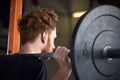 Rear View Of Young Man In Gym Lifting Weights On Barbell Royalty Free Stock Photo