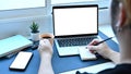 Young man holding coffee cup and writing information on notebook. Royalty Free Stock Photo