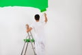 Man Painting Wall With Green Paint Roller Royalty Free Stock Photo