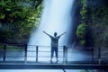 Young man enjoying Situ Gunung waterfall view