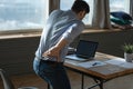 Rear view young man suffering from sudden backache at workplace Royalty Free Stock Photo