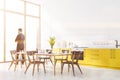 Man in white kitchen with yellow countertops Royalty Free Stock Photo