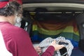 Rear view of a young man taking out the surfboard from the trunk of a car Royalty Free Stock Photo