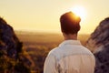 Rear view of young man watching sunset during hiking Royalty Free Stock Photo