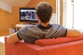 Rear view of young man watching television Royalty Free Stock Photo
