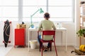 Rear view of young teenage student boy doing homework at home Royalty Free Stock Photo