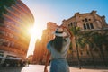 Rear view of young tourist woman in white sun hat walking in Malaga city at sunset. Summer holiday vacation in Spain Royalty Free Stock Photo