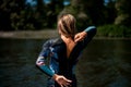 Rear view of woman in wetsuit with the zipper open.